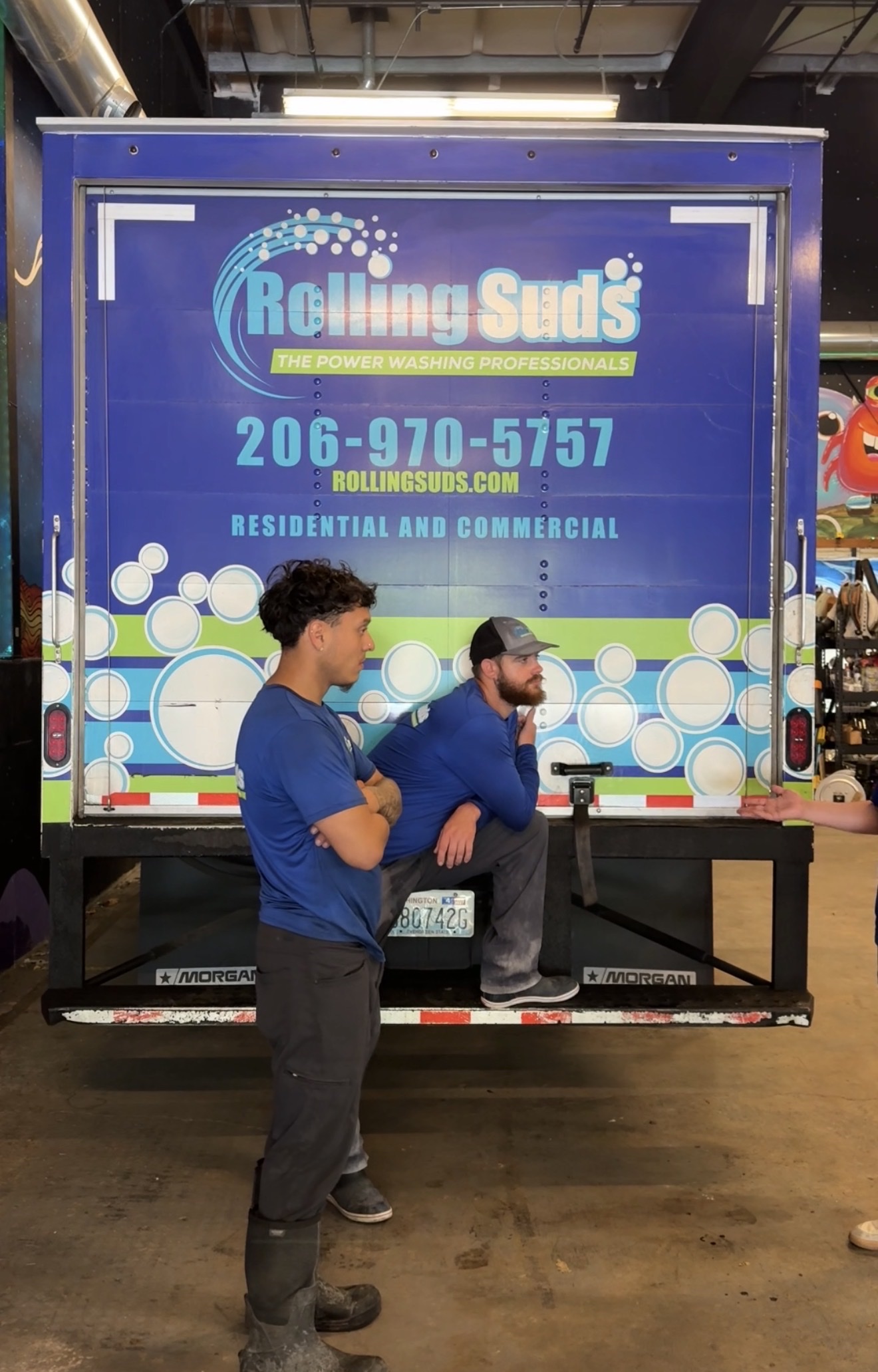 Rolling Suds team members with branded service truck